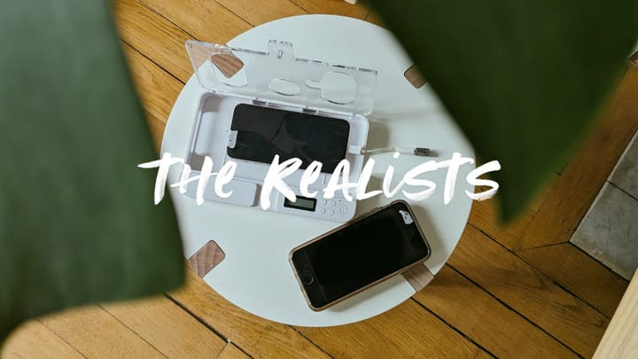A photo showing two smartphones on a small round white table